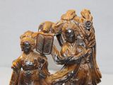 two figurines of a woman and a child on a table