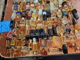 many bottles of alcohol sitting on a table with a price tag