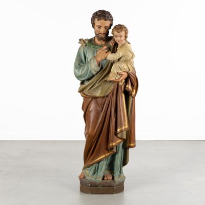 a statue of jesus holding a child in his arms