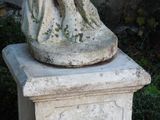 a statue of an angel sitting on top of a pedestal