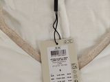 a white shirt with a tag on the front of it