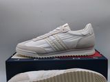 a pair of white sneakers sitting on top of a box