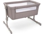 a baby crib with a baby bed attached to it ' s side