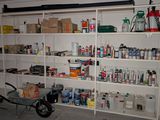 a wheelbarrow in front of a shelf full of cleaning supplies