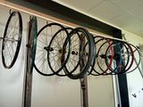 a lot of bikes that are hanging on the wall