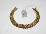 a close up of a gold bracelet with a price tag on it