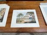 three prints on a wooden table with papers on it