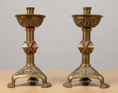 Paire de bougeoirs en bronze doré à décor de croix votive.
