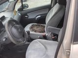 the interior of a car with the door open and the driver seat down