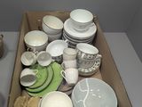 a box full of dishes and cups on a table
