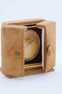 a small clock inside of a small box on a white surface