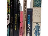 many books that are stacked on top of each other