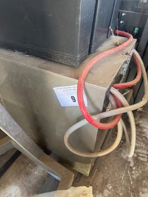 a metal box with a red hose attached to it