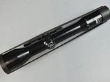 an image of a black pen laying on top of a white table