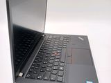 a laptop with a black keyboard on a white surface