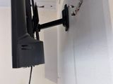 a tv mounted on the wall in the corner of a room