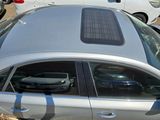 a silver car with a solar panel on top of it