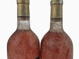 two bottles of wine sitting next to each other on top of a table