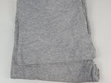 a close up of a gray blanket on a white table