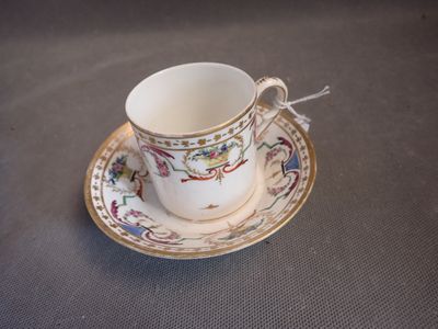 a cup and saucer sitting on a table