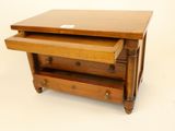 a small wooden table with two drawers on top of it
