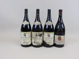 quatre bouteilles de vin sont alignées sur une surface blanche