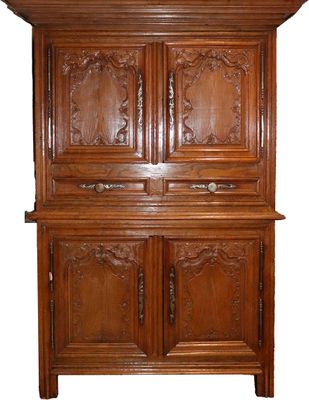 an image of a wooden cabinet with carvings on the doors