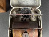 a small metal box with a small metal object inside of it