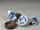 three small blue and white vases and a small red and white vase