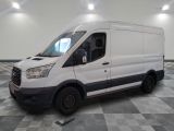 the white van is parked on a checkered floor in a room