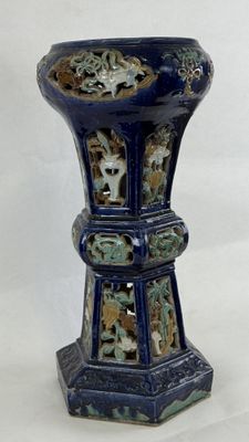 a blue vase with a design on it on a white background