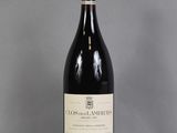 a bottle of red wine sitting on top of a table