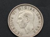 a close up of a silver coin with a man ' s face on it