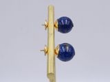 pair of lapis and gold earrings on a gold plated stand