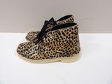 leopard print booties with black laces on a white surface