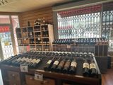 many bottles of wine sitting on a table in a store