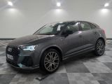 a grey audi qx parked on a checkered tile floor