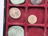 a lot of coins in a red box on a table