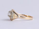 an image of a gold ring with a diamond