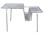 a metal table with a magazine holder on it