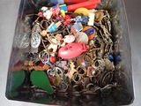 a container filled with assorted key chains and other items