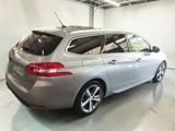 the rear end of a silver car in a garage