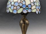a close up of a lamp on a table with a gray background