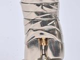 a silver sculpture of a torso on a pedestal