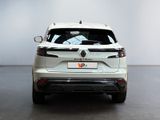 the rear end of a white car parked in a room