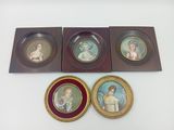 three framed pictures of a woman and a child on a white surface