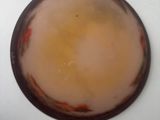 a picture of a bowl of liquid on a white surface
