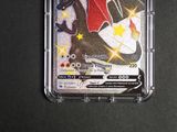 a close up of a pokemon trading card in a plastic case