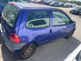 a small blue car that is parked in a parking lot