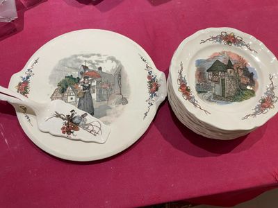 two plates on a table with a pink table cloth